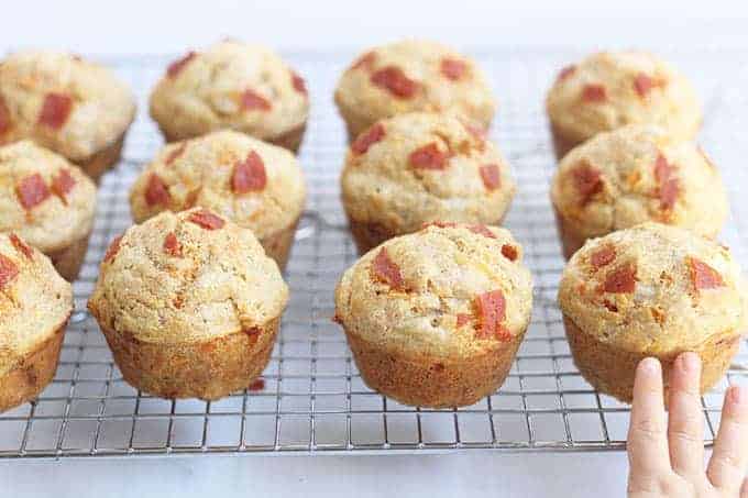 pizza-muffins-on-wire-rack-with-kids-hand